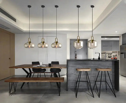 Six modern smoked-glass pendant lights with brass hardware for kitchen dining area on Tampa Home & Garden Store