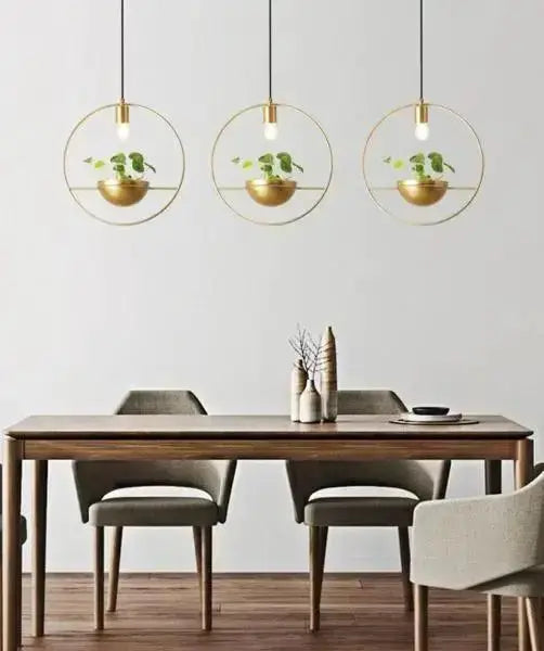 Nordic gold planter pendant light trio with circular frames and potted plants over dining table on Tampa Home & Garden Store
