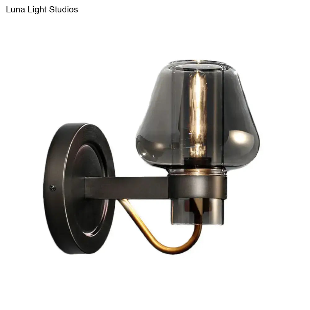 Black brass mushroom sconce with smoked glass shade and curved brass arm by Decorbites on Tampa Home & Garden Store