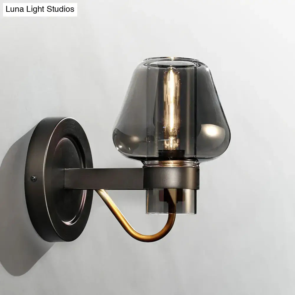 Black brass mushroom sconce with smoky glass shade and exposed filament bulb on Tampa Home & Garden Store