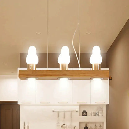 Modern wood and white glass island light pendant with three bulbs over kitchen island on Tampa Home & Garden Store