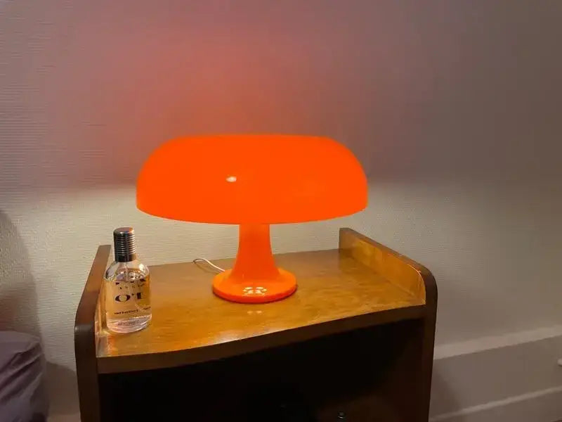 Decorbites black LED mushroom table lamp on a bedside table emitting warm orange glow on Tampa Home & Garden Store