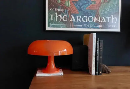 Orange LED mushroom table lamp by Decorbites on wood desk beside books against dark wall on Tampa Home & Garden Store