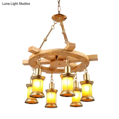 Rustic industrial wood spool pendant chandelier by Decorbites with six warm amber lanterns on Tampa Home & Garden Store