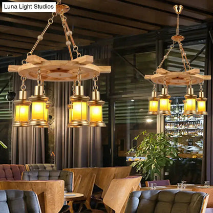 Rustic industrial wood spool pendant chandeliers with warm amber lanterns, dining room pair on Tampa Home & Garden Store
