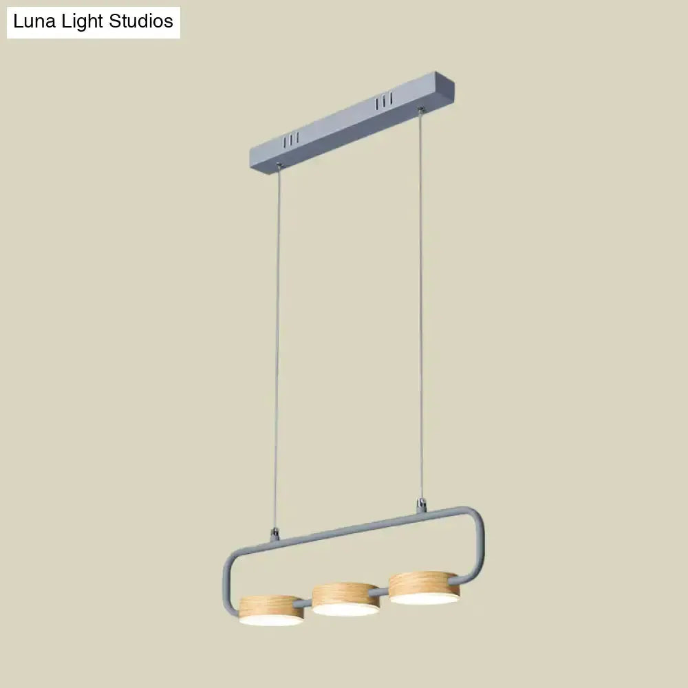 Three-light mint green pendant light with wood ring accents and grey frame for kitchen island on Tampa Home & Garden Store