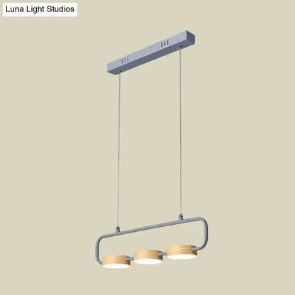 Three-light mint green pendant light with wood ring accents and grey frame for kitchen island on Tampa Home & Garden Store