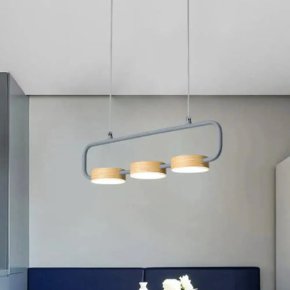 Modern mint-green three-light pendant with wood accents over kitchen island on Tampa Home & Garden Store