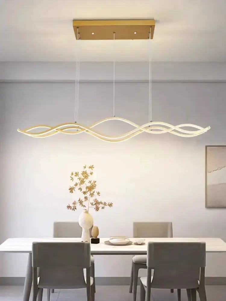 Decorbites modern white wavy LED pendant chandelier hanging over a dining table on Tampa Home & Garden Store