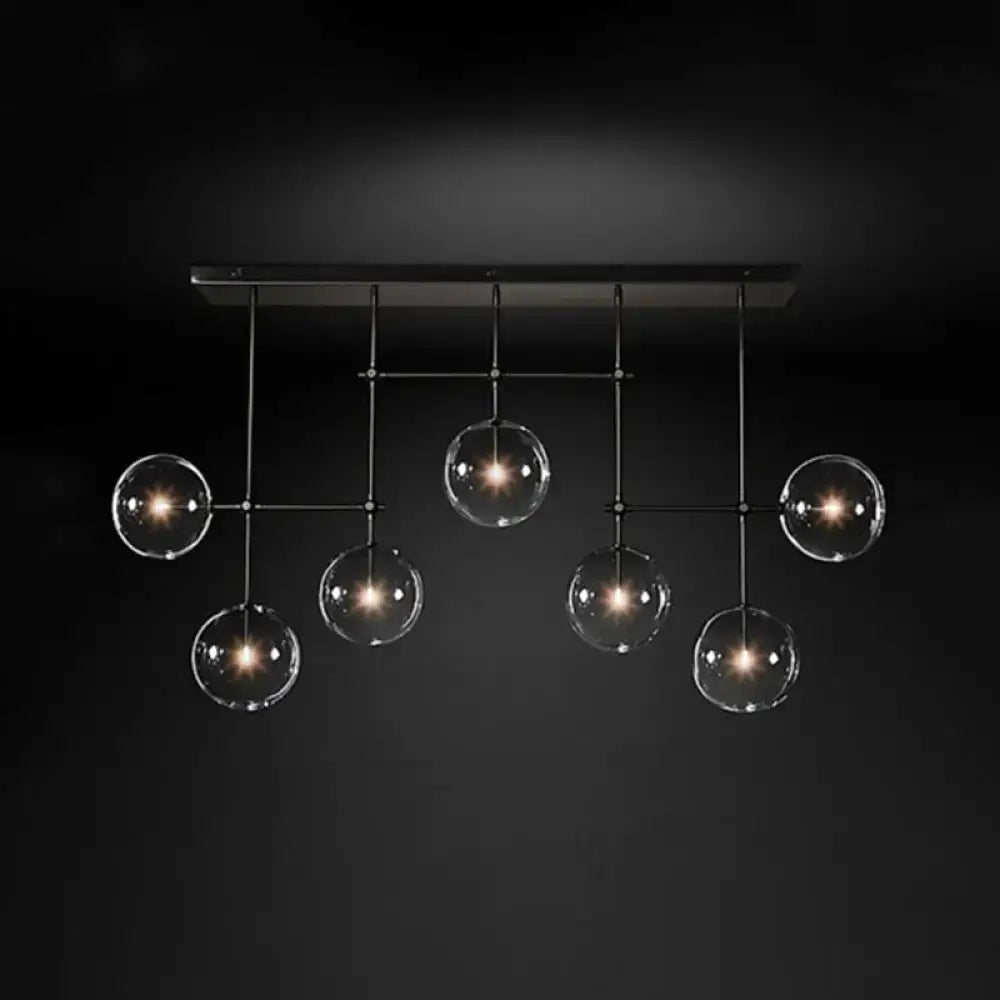 Black Gold Sphere Light with six clear glass globes hanging from a black metal frame on Tampa Home & Garden Store