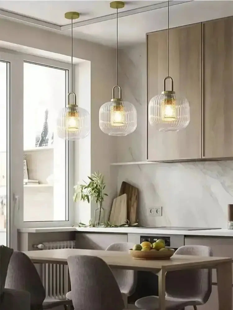 Pendant lights: three vintage brass glass globe pendants over a dining table in a modern kitchen on Tampa Home & Garden Store