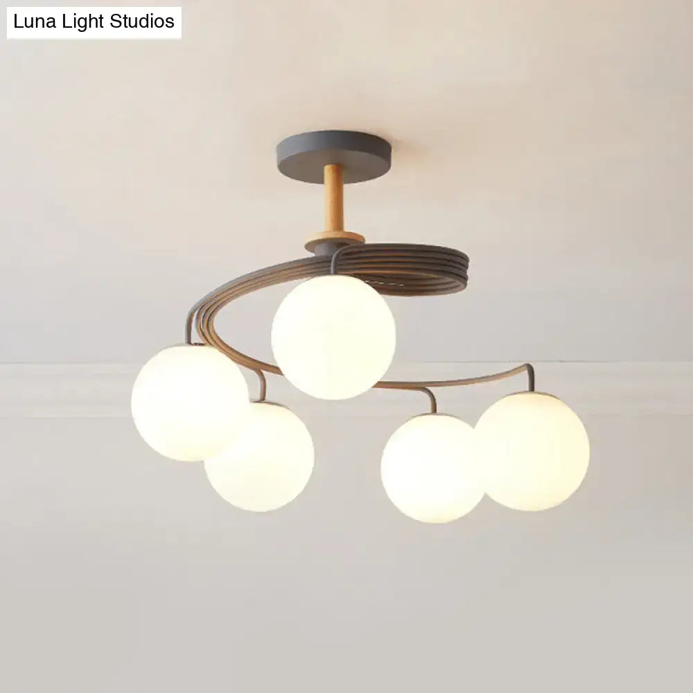 Green Grey Orb Chandelier by Decorbites; modern metal arches cradle five glowing glass globes on Tampa Home & Garden Store