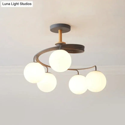 Green Grey Orb Chandelier by Decorbites; modern metal arches cradle five glowing glass globes on Tampa Home & Garden Store