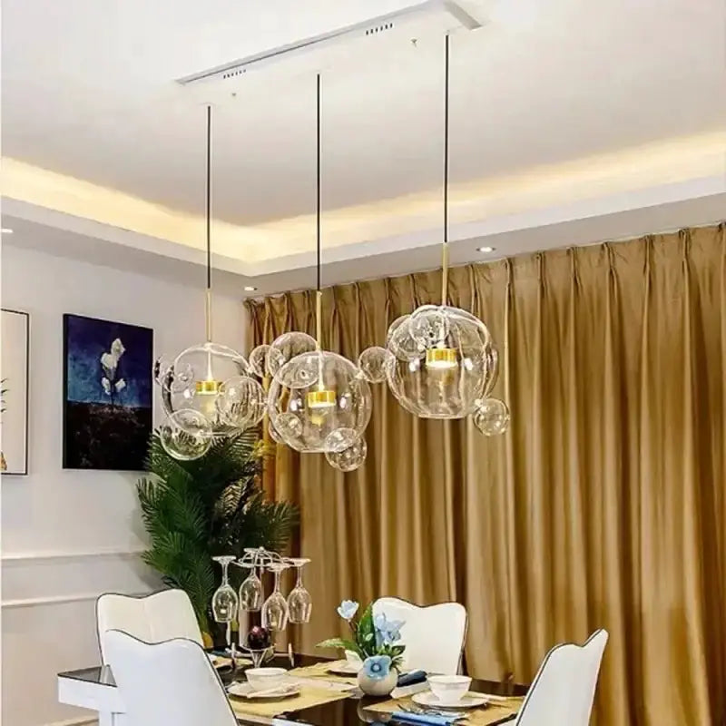 Modern 7-globe glass LED chandelier with clear bubble globes and gold accents in living room on Tampa Home & Garden Store