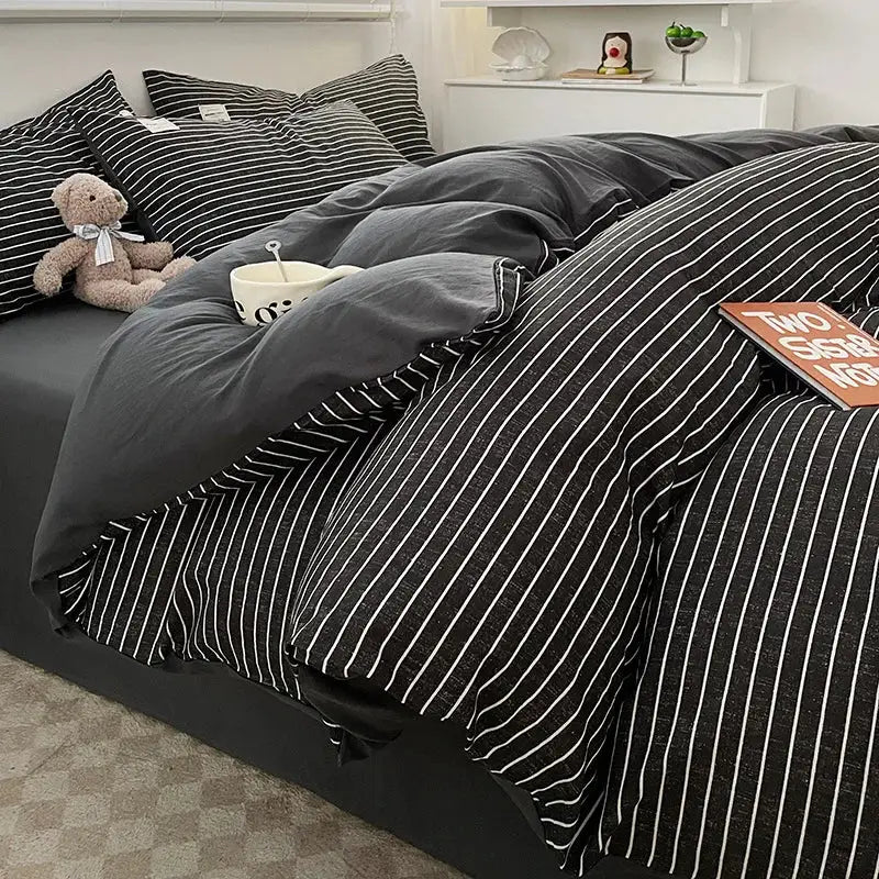 Duvet cover set in charcoal gray with white stripes, matching pillow shams and solid reverse on Tampa Home & Garden Store