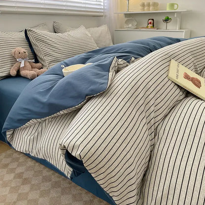 Nordic plaid green cotton duvet cover set by Decorbites with blue reverse and striped pillows on bed on Tampa Home & Garden Store