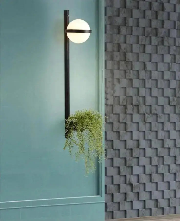 Modern black Nordic planter light sconce with glass globe and trailing greenery Decorbites on Tampa Home & Garden Store
