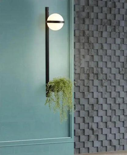 Modern black Nordic planter light sconce with glass globe and trailing greenery Decorbites on Tampa Home & Garden Store