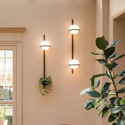 Two modern black Nordic planter light sconces with glass globes, hanging planter on Tampa Home & Garden Store