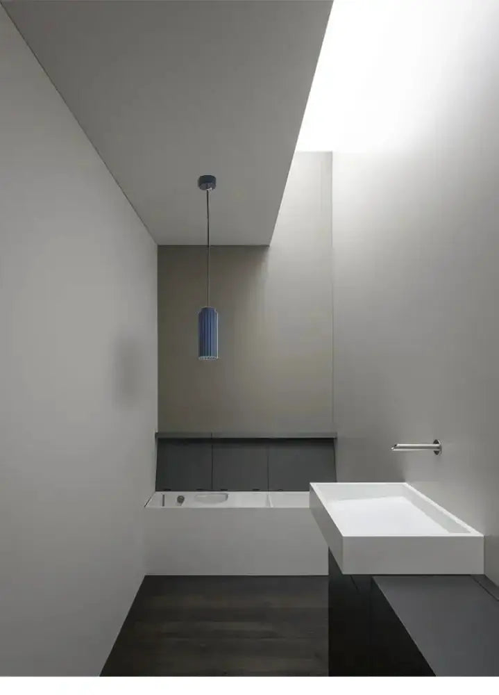 Chandelier Decorbites blue cylindrical pendant light in a minimalist bathroom setting on Tampa Home & Garden Store