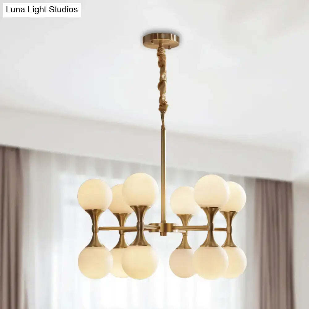 Brass globe chandelier by Decorbites with frosted glass globes on brass arms on Tampa Home & Garden Store