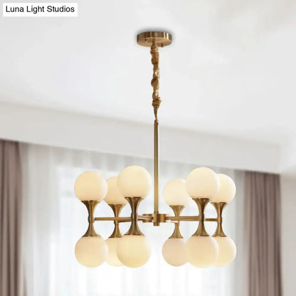 Brass globe chandelier by Decorbites with frosted glass globes on brass arms on Tampa Home & Garden Store