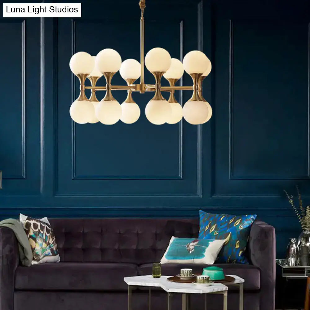 Brass globe chandelier with frosted glass globes by Decorbites on Tampa Home & Garden Store