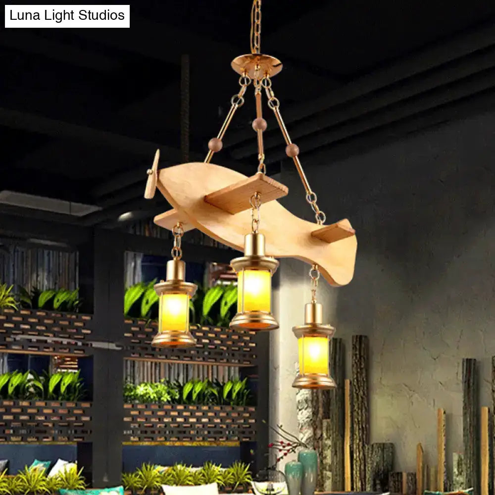 Vintage gold woven pendant light with orange glass lanterns suspended from a wooden canopy on Tampa Home & Garden Store