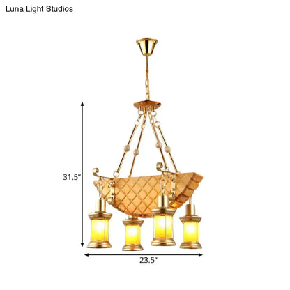 Vintage gold woven pendant light with a basket shade and four orange glass lanterns on Tampa Home & Garden Store