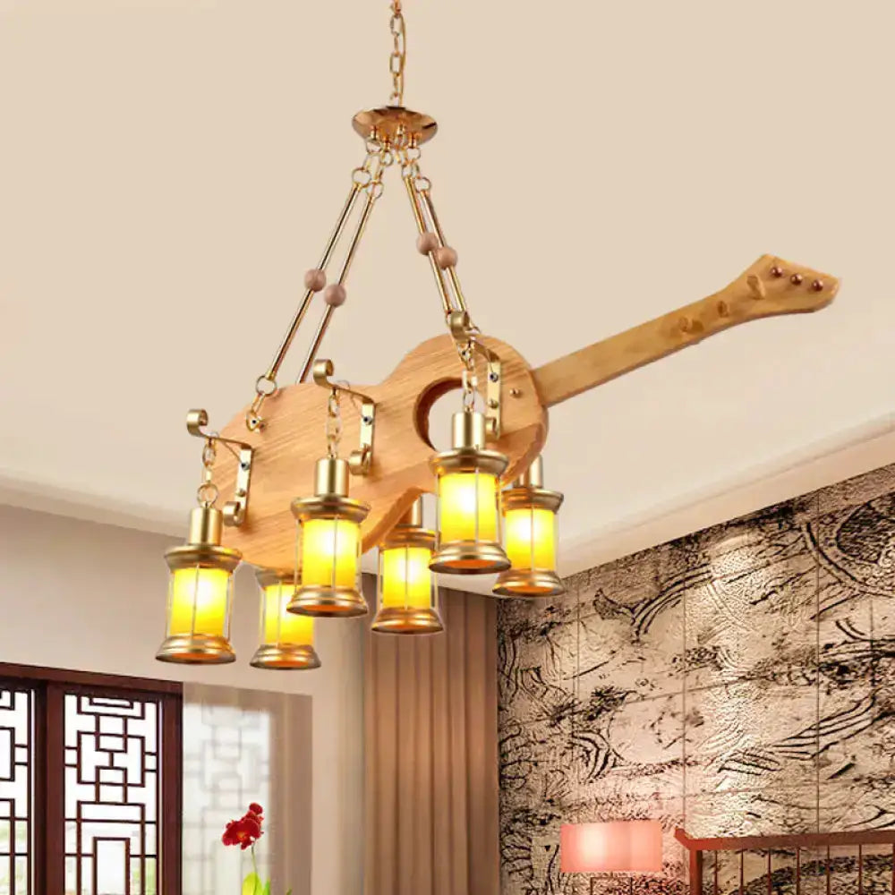 Decorbites gold woven pendant light, guitar-shaped fixture with orange glass lanterns on Tampa Home & Garden Store