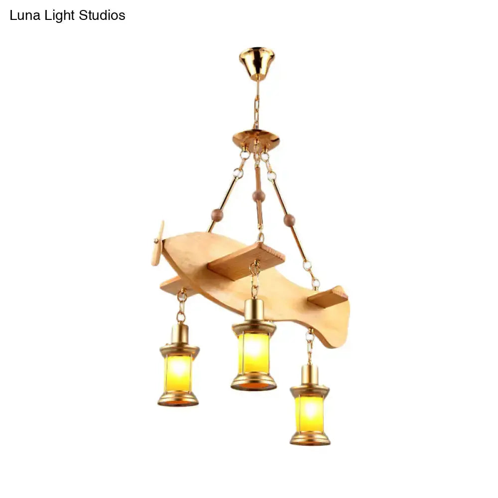 Vintage gold woven pendant light with three orange glass lanterns from a fish-shaped frame on Tampa Home & Garden Store