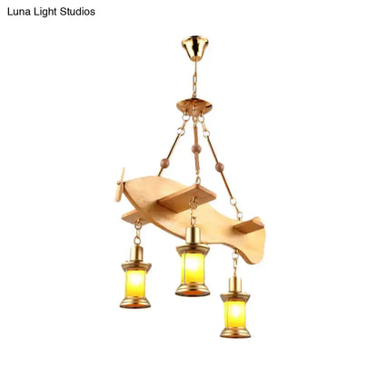 Vintage gold woven pendant light with three orange glass lanterns from a fish-shaped frame on Tampa Home & Garden Store