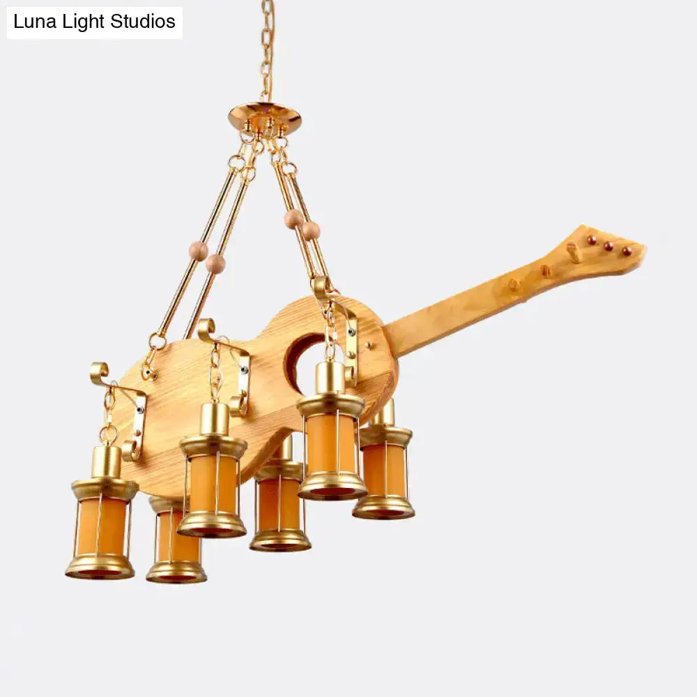 Guitar-shaped pendant light with wooden body and orange glass lanterns by Decorbites on Tampa Home & Garden Store