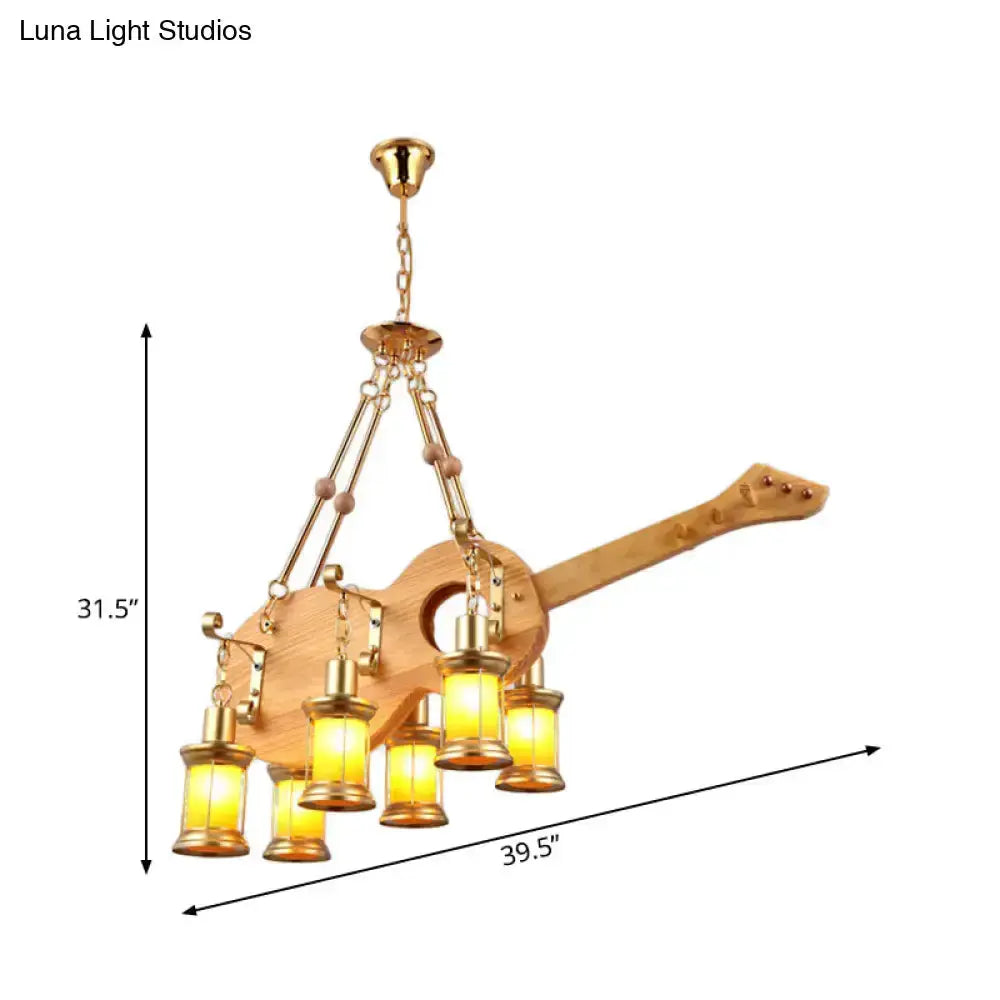 Vintage gold woven guitar-style pendant light with five orange glass lanterns, chain hung on Tampa Home & Garden Store