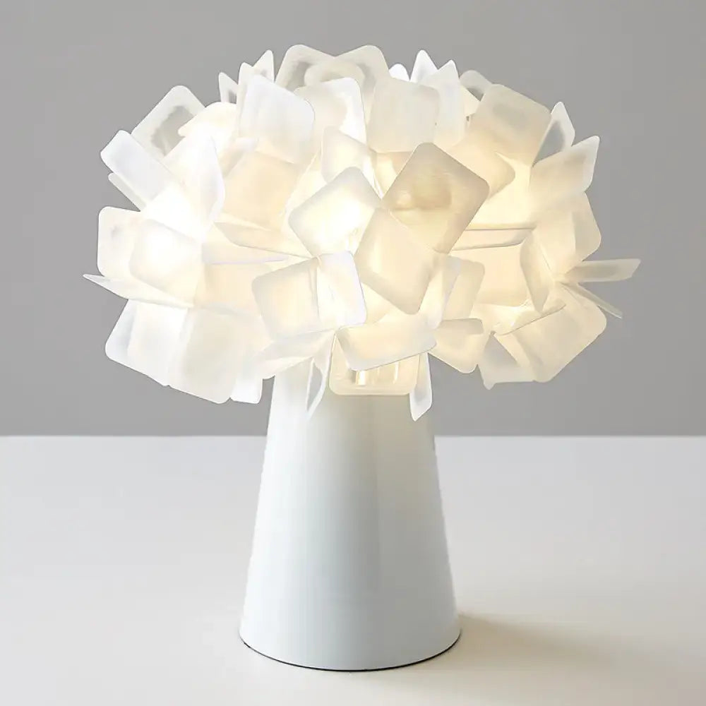 White origami table lamp with a shade of folded square panels atop a tapered white base on Tampa Home & Garden Store