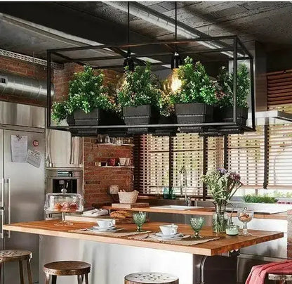 Decorbites industrial black metal planter light chandelier with greenery above a kitchen island on Tampa Home & Garden Store