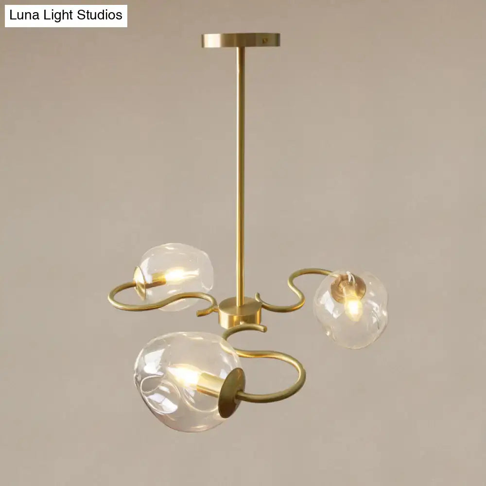 Brass Glass Globe Flush Mount Decorbites with three glass globes on curved brass arms on Tampa Home & Garden Store
