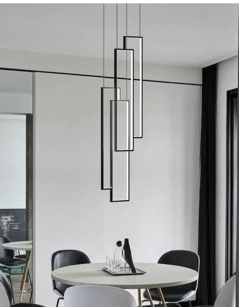 Rectangle LED chandelier in black and gold by Decorbites hanging over a round dining table on Tampa Home & Garden Store