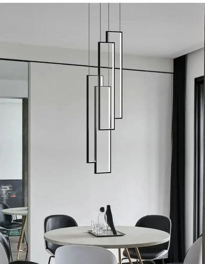 Rectangle LED chandelier in black and gold by Decorbites hanging over a round dining table on Tampa Home & Garden Store