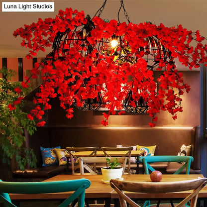 Red Diamond Cage Pendant light in black metal cage with red flowers above a cozy dining area on Tampa Home & Garden Store
