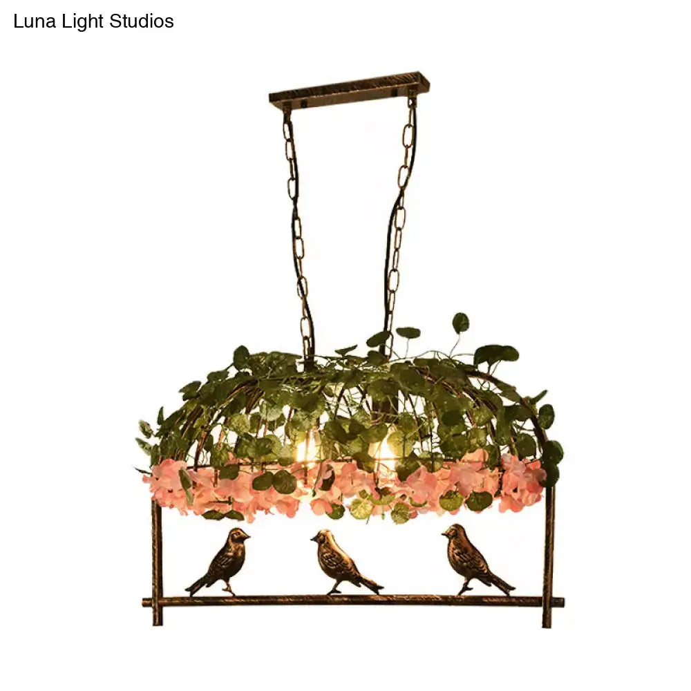 Brass Birdcage Ceiling Light chain-hung with greenery, pink blooms, and three birds on base on Tampa Home & Garden Store