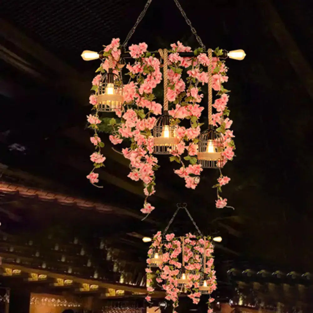Metal Ivy Island Light pendant with cage lanterns wrapped in pink flowers and ivy by Decorbites on Tampa Home & Garden Store