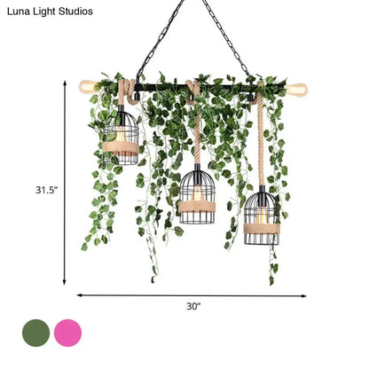 Metal Ivy Island Light pendant lights by Decorbites, three black metal cage pendants with wood accents amid trailing ivy on Tampa Home & Garden Store