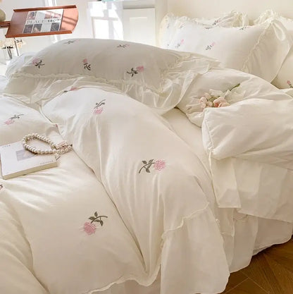 Princess white rose embroidered duvet cover set with ruffled edges by Decorbites on white bed on Tampa Home & Garden Store
