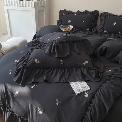 Duvet set Decorbites black ruffled with pink rose embroidery and two matching shams on bed on Tampa Home & Garden Store