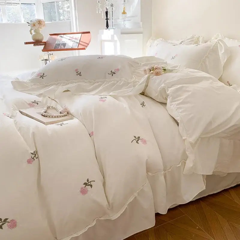 White ruffled duvet set by Decorbites with pink floral embroidery on Tampa Home & Garden Store