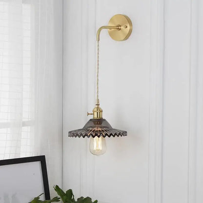 Smoked Glass Brass Sconce; wall mount, curved arm, scalloped smoked shade with Edison bulb on Tampa Home & Garden Store