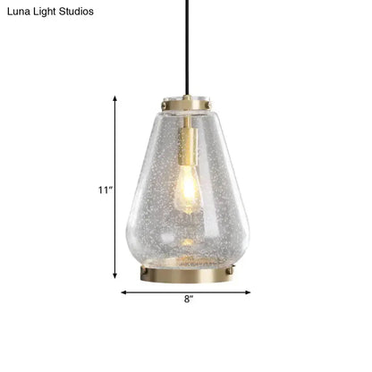 Modern seeded glass pendant light with brass rim, clear teardrop shade, 11in tall 8in wide on Tampa Home & Garden Store