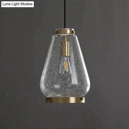 Modern seeded glass pendant light with brass rim and visible filament bulb by Decorbites on Tampa Home & Garden Store
