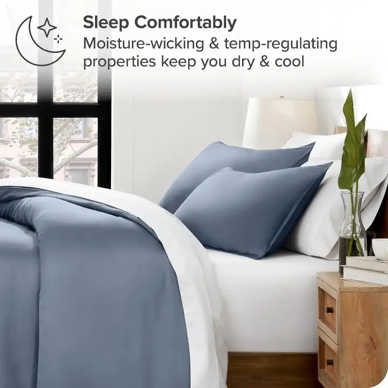 Blue satin duvet cover set by Decorbites with blue shams on white bed on Tampa Home & Garden Store